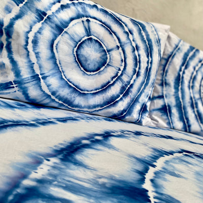 Close-up of blue and white tie-dye fabric with concentric circle pattern